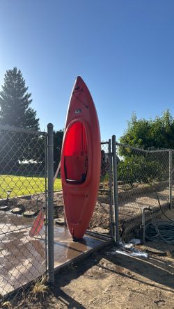 This is a Lifetime Pacer 8 ft Sit-Inside Kayak in orange, featuring a compact design perfect for calm lakes and rivers