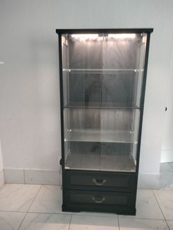 Tall glass enclosed shelving