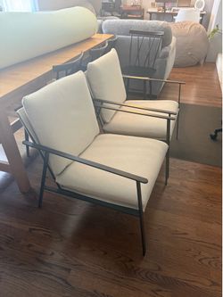 2 Black metal framed chairs