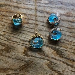  gold-tone ocean wave pendant necklace Matching earrings and a Adjustable ring
