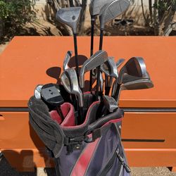 Golf clubs with bag and a bunch of golf balls