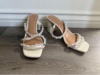 Cream pearl embellished sandals.