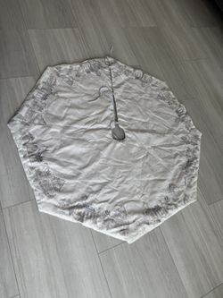 ecorative Christmas tree skirt used to cover the stand at the base of the tree.