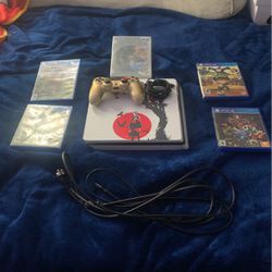 PS4 With Power And HDMI Cords, A Controller, A charger for the controller, and 5 games 