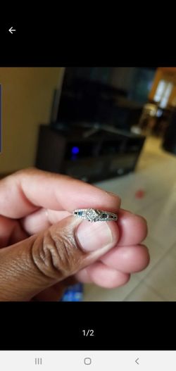 White gold promise ring. 10k diamond with blue sapphire jewel.