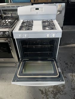 GE white gas stove with a receipt for a 60-day warranty