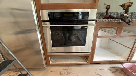 Sleek Monogram stainless steel double oven. Built-in style. Clean finish and glass door. Has a digital control panel.