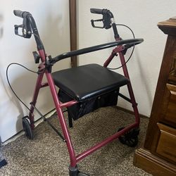 Drive Medical 4-Wheel Rollator with a padded seat and storage pouch.