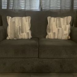 Gray loveseat Couch with Pillows. 