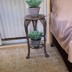 Cast Iron 2 Tier Shelf For Patio Or Interiors, Includes Two Faux Yucca Plants, Excellent Condition! Please Make Reasonable Offer!