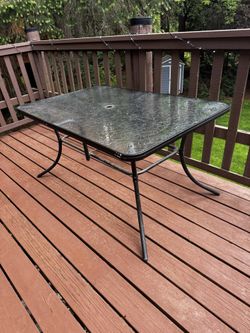 Outdoor glass top table a rectangle.  56” X 35.5” X 28”