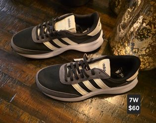 Adidas Women's Run 70s sneakers feature a black mesh upper with suede overlays and white stripes.