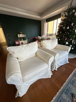 Two white arm chairs