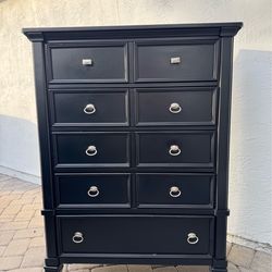 Ashley Furnitures tall black wooden dresser