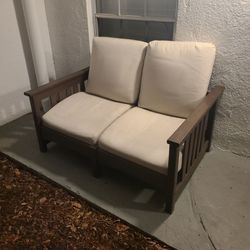 Solid resin loveseat with cushions