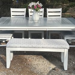 Table , leaf 5 chairs and a bench