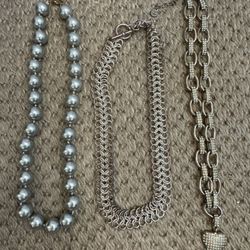 Three statement necklaces. Pearls, silver design, and chunky heart necklace