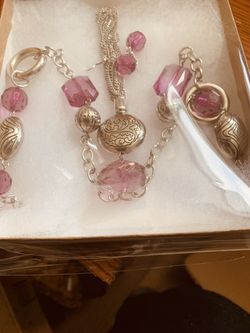 Extra long beautiful transparent fuchsia and gold plated necklace with matching earrings.