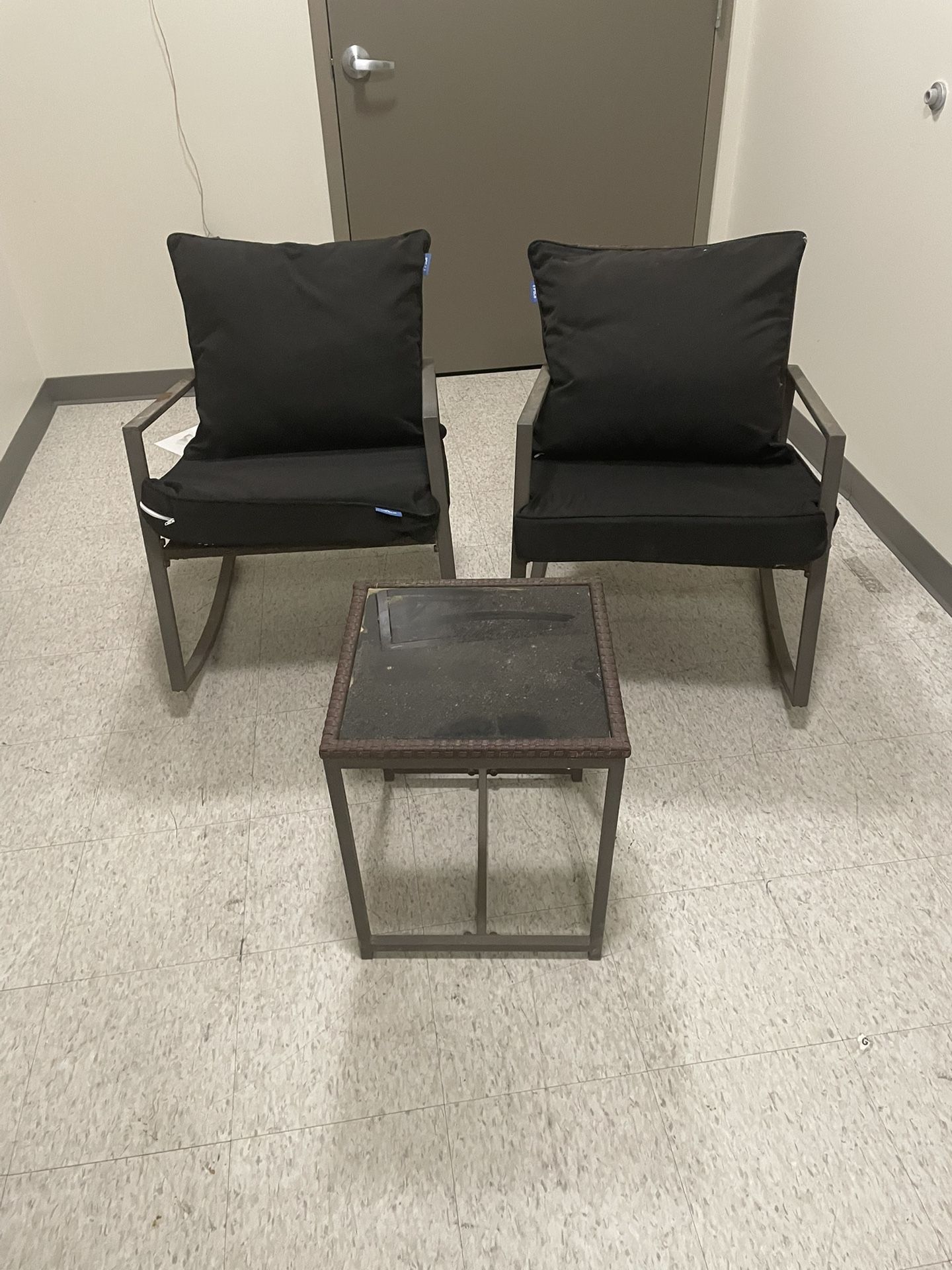 Patio Set. Both Chairs Are Rocking Chairs. One Of The Chair Has A Rust Spot .