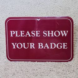Please Show Your Badge desk table counter desktop tabletop countertop lobby entryway greeting sign