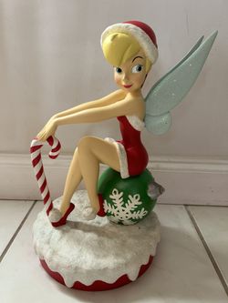 Tinkerbell Big Fig Sitting On A Christmas Ornament With Candy Cane.