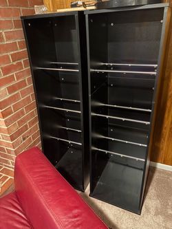 Two black shelving piers, ideal for records