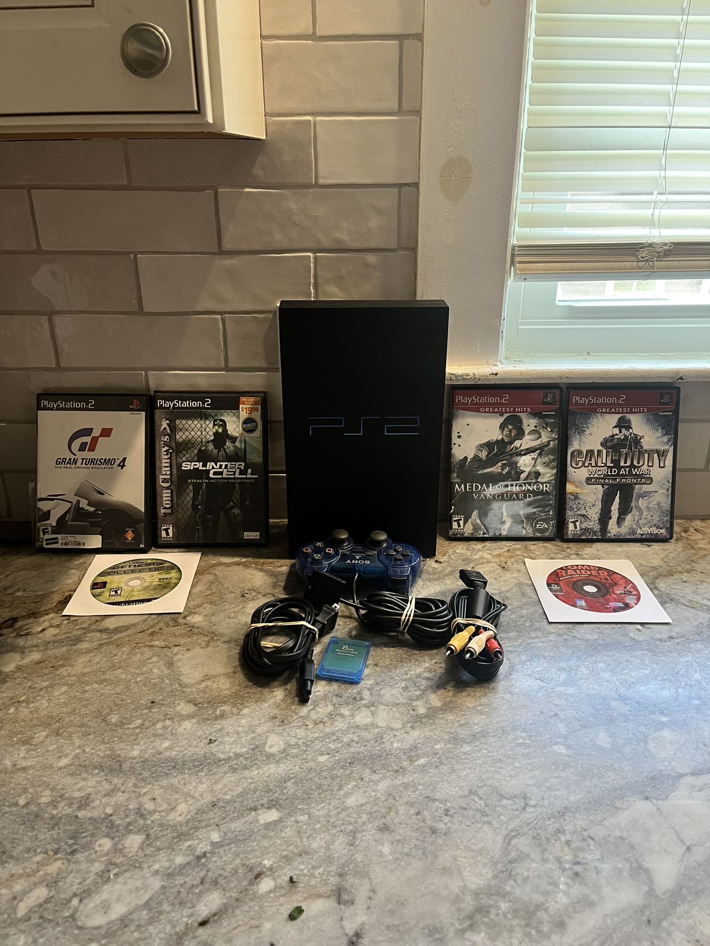 Pristine condition PS2 with Classic PS2 games, aswell as all the wires. Controller and memory card included