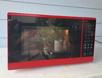 Mainstays 0.7 Cubic Foot 700-Watt Countertop Microwave Oven in red.