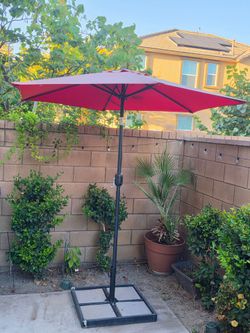 Red Umbrella patio yard with holder included need it gone asap