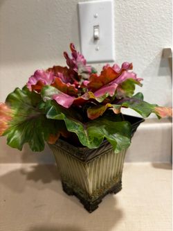 Artificial cabbage flower in green metal container