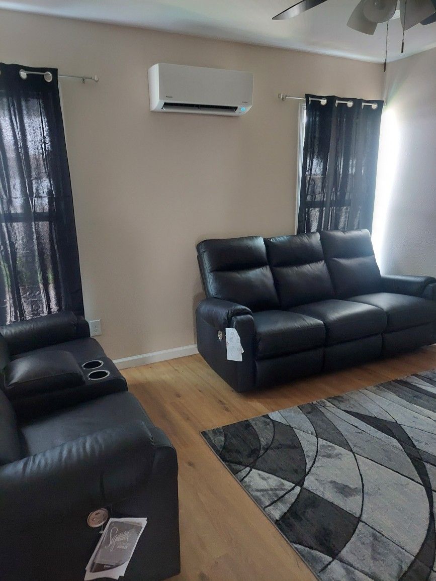 75 inch TV an sofa and love seat and a glass table