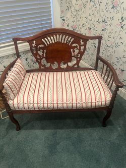 Antique Carved Wood Settee with Striped Cushion