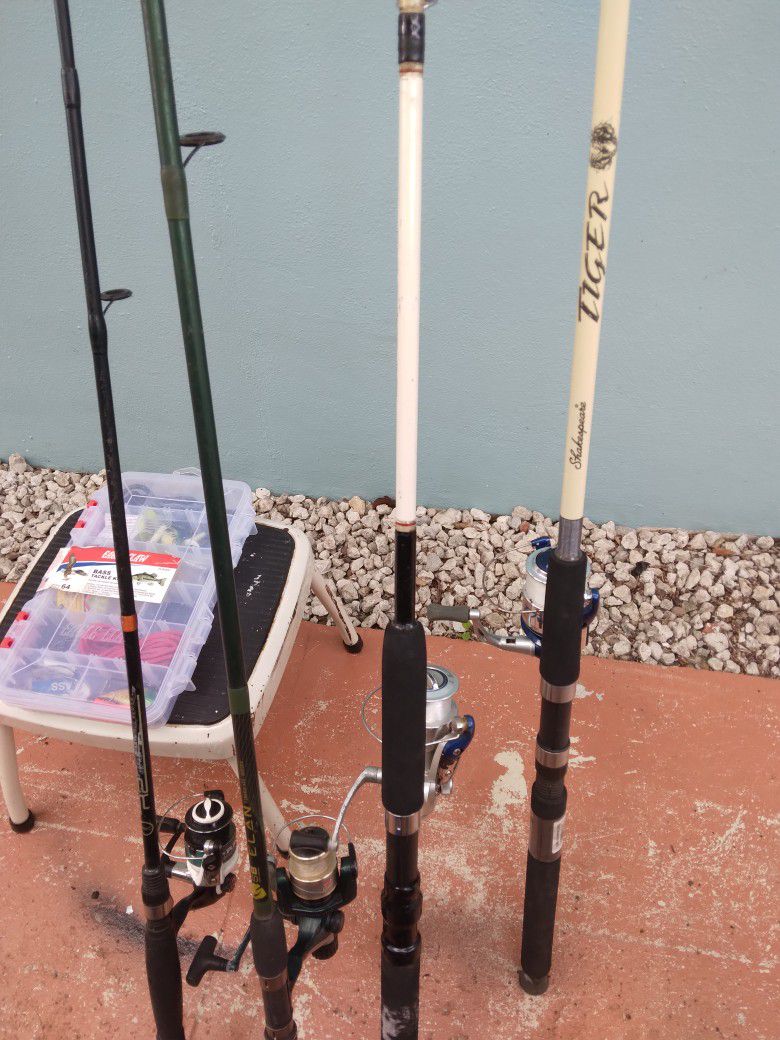 4 Fishing Poles With A Tackle Box