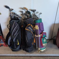 Three bags of golf clubs