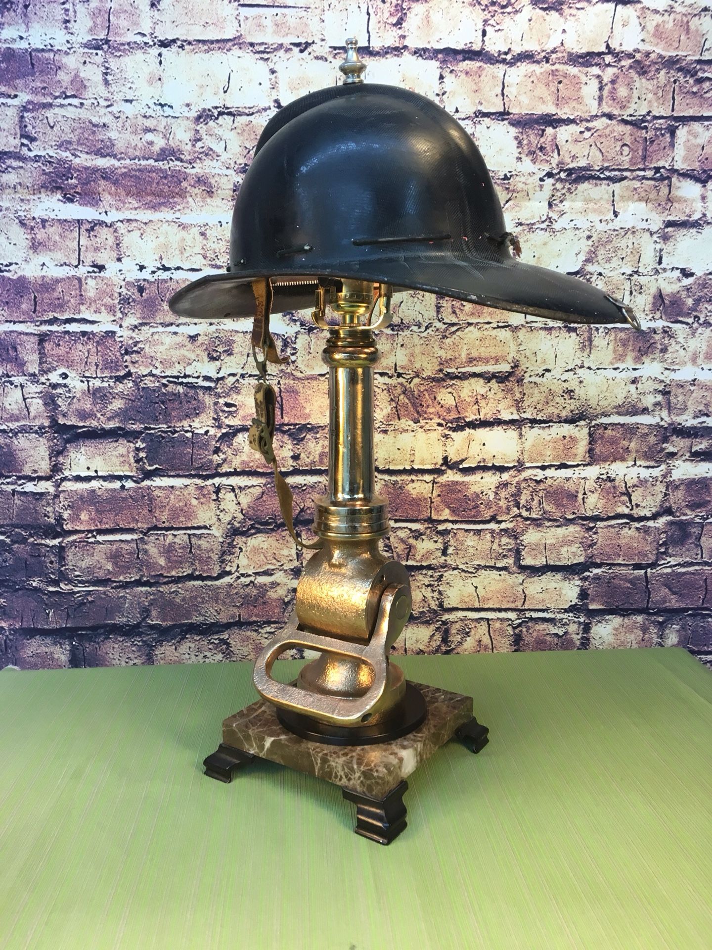 Vintage collectable brass fire nozzle make into a custom lamp with vintage fire helmet for a lamp shade