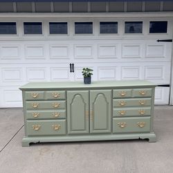 Large green dresser with gold hardware