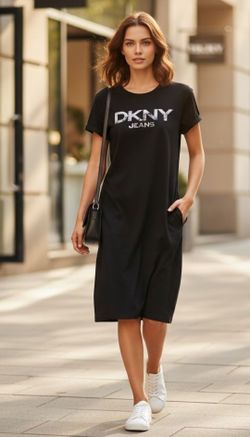 "DKNY Jeans" Women’s Size XL Black Short Sleeve Logo Graphic T-Shirt Mini Dress. This black DKNY T-Shirt dress features a prominent distressed silver