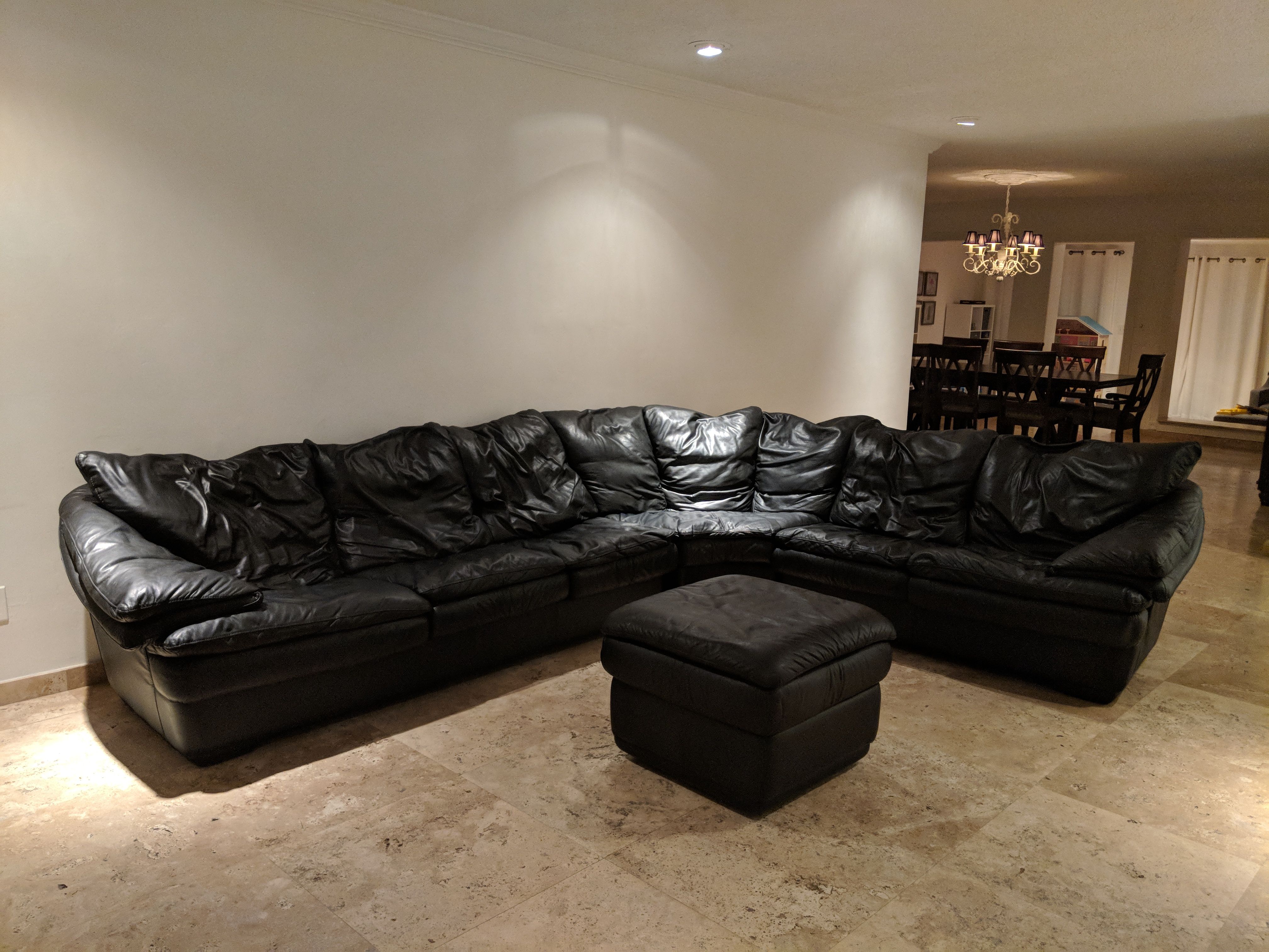 Genuine leather black sectional couch with ottoman - great condition!
