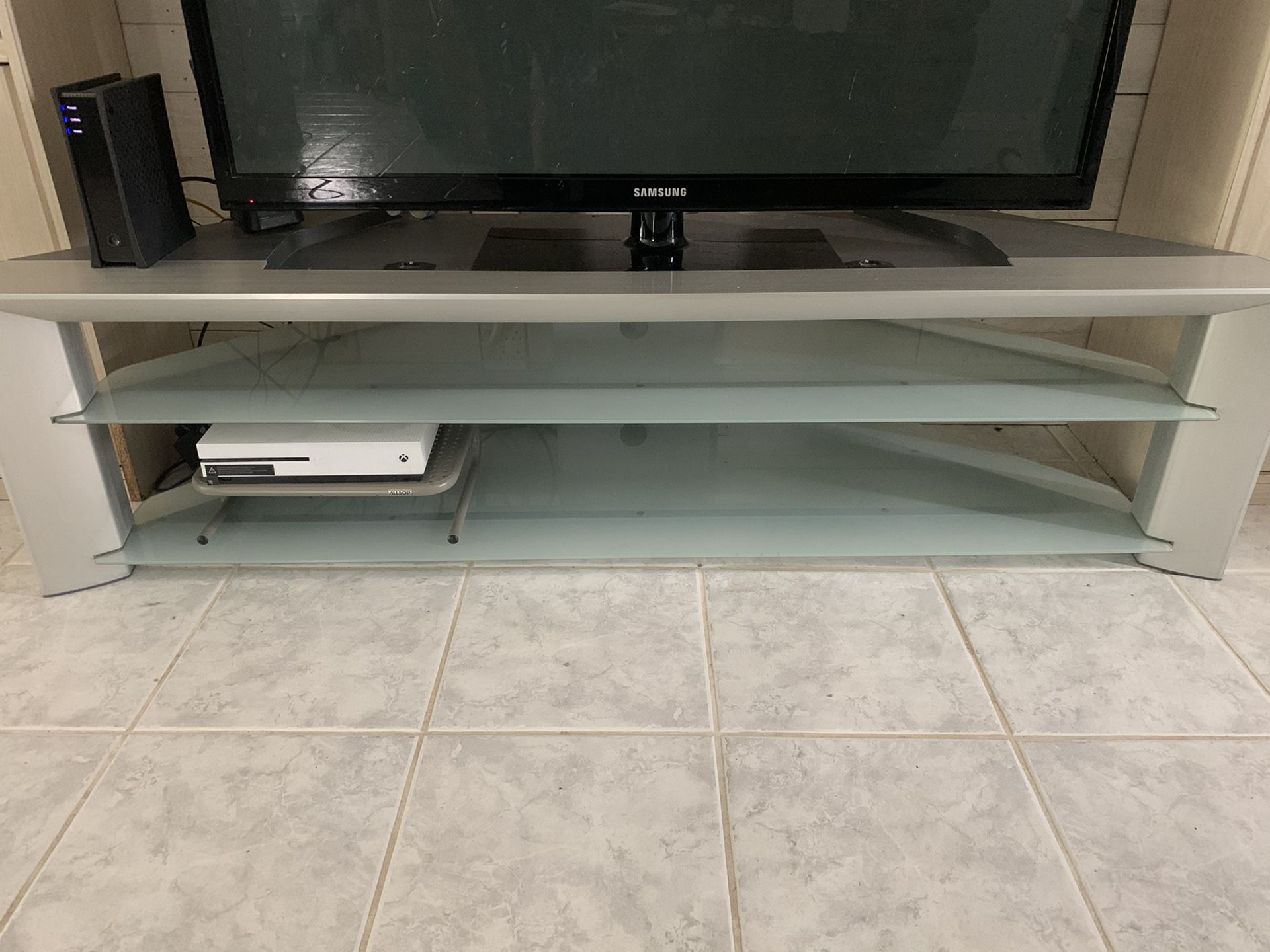 Silver TV stand with Glass shelves.