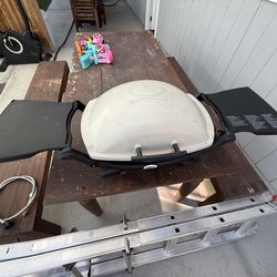 Weber portable gas grill with extended gas connection line