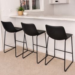 Modern black bar stools with a sleek, minimalist design