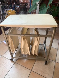 Laundry hamper with folding table