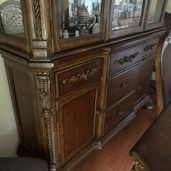 It’s a China cabinet with a table with six chairs. It has a leaf in the middle. You can make it bigger.
