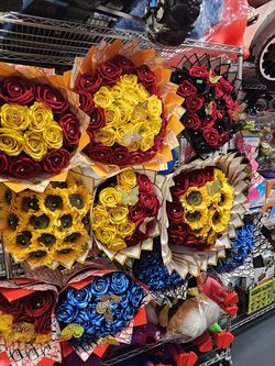 The bouquets are made of artificial flowers, including roses, lilies, and other types of flowers. They are arranged in various colors and styles, with
