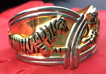 Bangle hinged silver and gold tone bracelet