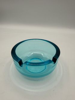 This is a vintage J. Wuidart & Co. mid-century modern turquoise blue glass ashtray.