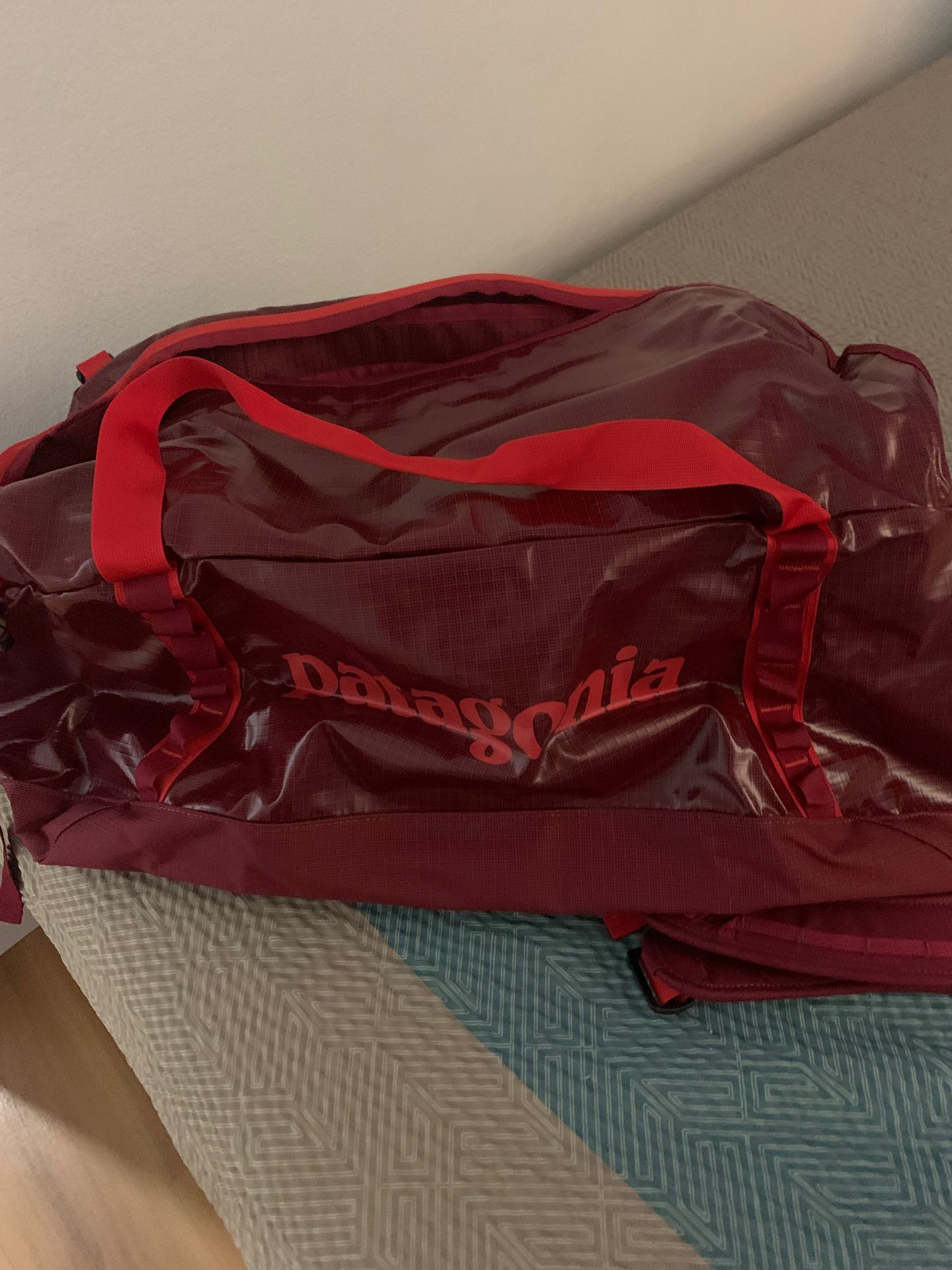 Brand new 70L blackhole duffel bag red brand new with tags retails at $159 before tax.