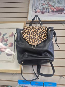 Dune London leather backpack featuring a leopard print calf hair flap and gold-tone hardware