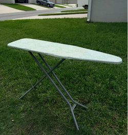 Selling a foldable ironing board with an iron rest.