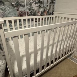 White wood baby crib with mattress